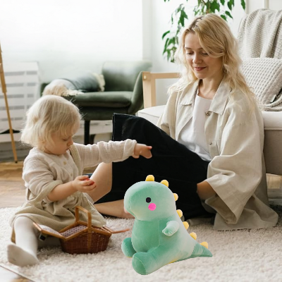 Petite fille joue avec ses jouets en compagnie sa peluche T-ex cuddles et sa maman assise à côté.